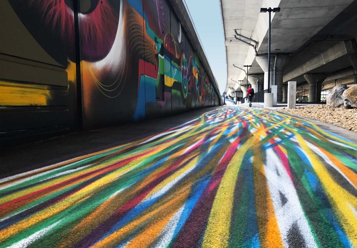 A colorful, striped pathway leads you through the artwork